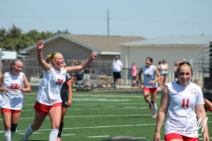 Lily Larka (Elkhorn) celebrates with her team.