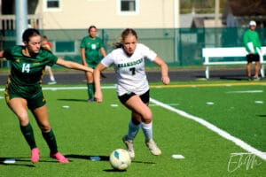 Tanner Schultz (Scotus CC) dribbles the ball downfield. 